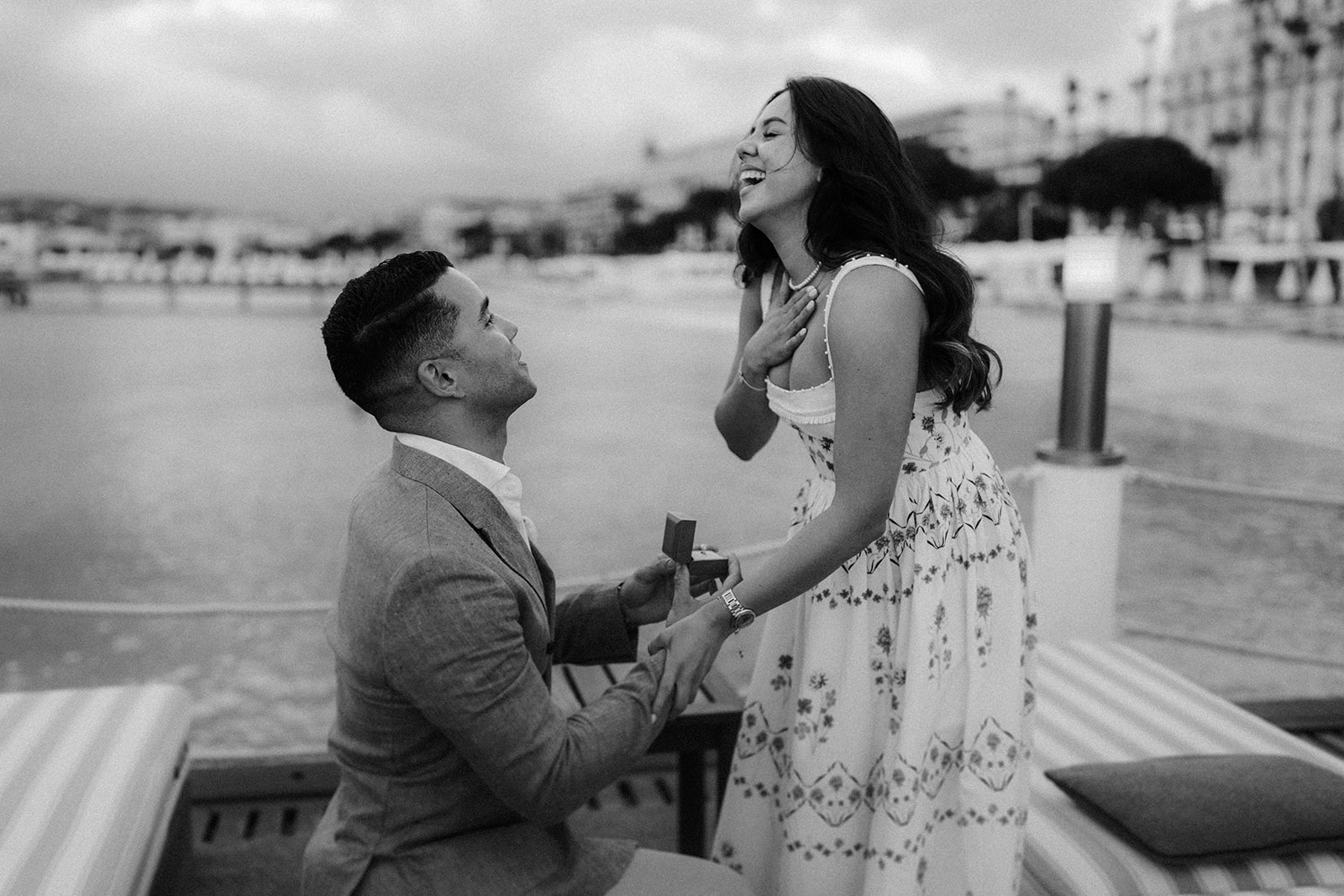 a black and white photo of a proposal on the Martinez Beach, cannes, French riviera