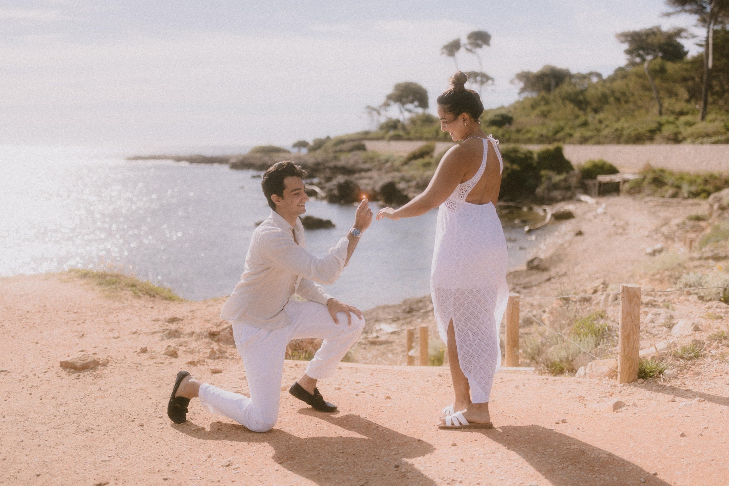 proposal at cap d'antibes on the French riviera proposal knee down cap d'antibes French Riviera - a man is proposing to his girlfriend with the sea in the background